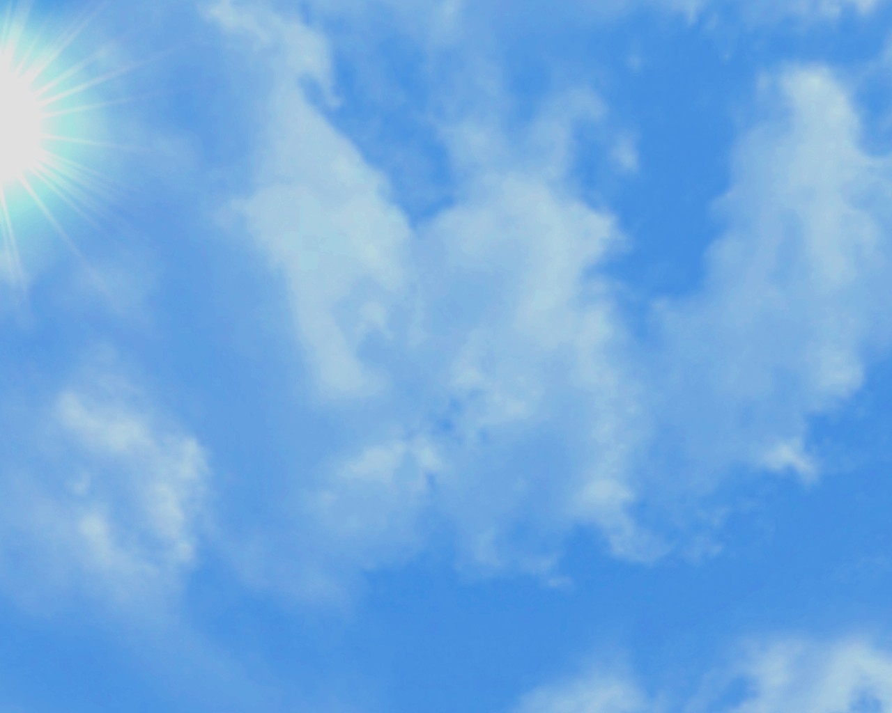 A bright starburst sun in the upper left corner of a deep blue sky with soft white clouds.